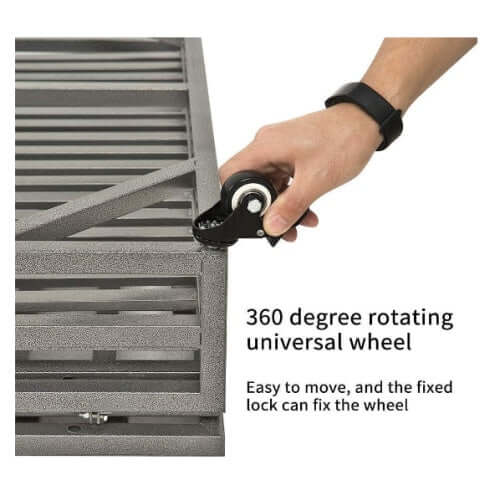 Close-up of a hand using a 360-degree rotating wheel on a heavy-duty pet kennel for easy mobility.